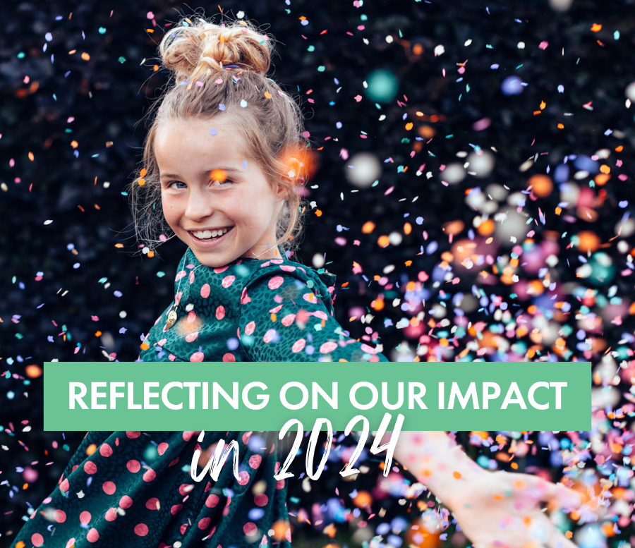 Darkness to Light: Reflecting on Our Impact in 2024. Little girl smiles at camera while throwing confetti